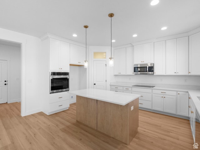 1018 S 3250 E Unit 128, Spanish Fork, UT 84660 - kitchen with appliances with stainless steel finishes, light wood-type flooring, white cabinetry, and a kitchen island