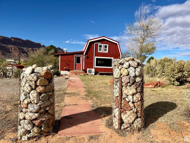 exterior space featuring a front lawn and an outbuilding