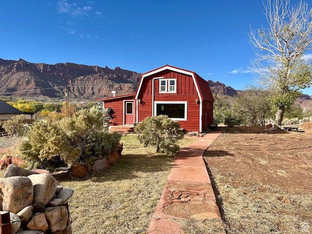 exterior space featuring a front lawn and a mountain view