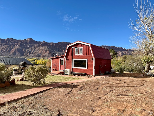 view of outdoor structure with a mountain view and ac unit