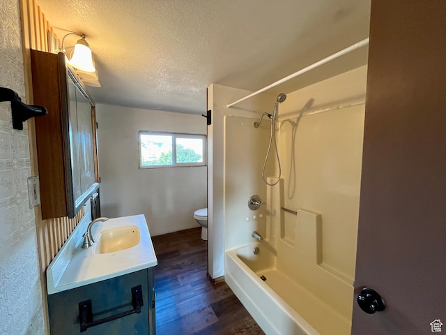full bathroom featuring shower / bath combination, toilet, a textured ceiling, hardwood / wood-style flooring, and vanity