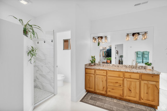 896 E Mesa Vista Dr, Ivins, UT 84738 - bathroom with concrete flooring, vanity, toilet, and a tile shower