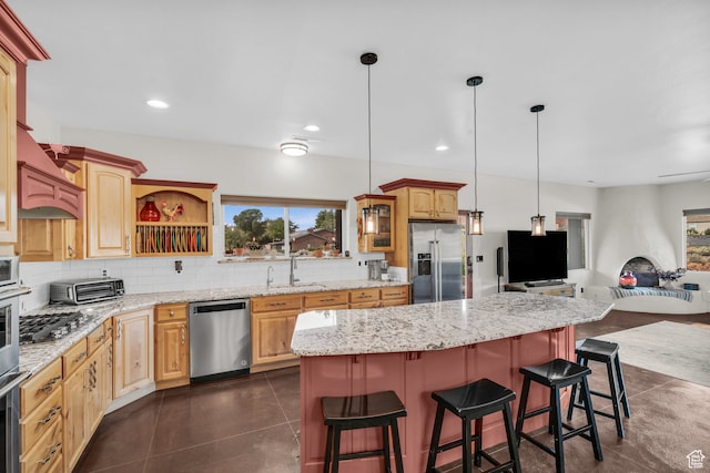 896 E Mesa Vista Dr, Ivins, UT 84738 - kitchen featuring stainless steel appliances, decorative backsplash, hanging light fixtures, a kitchen island, and a breakfast bar