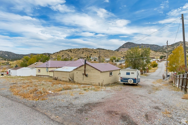 view of property exterior with a mountain view