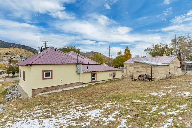 11 W Main St, Eureka, UT 84628 - back of house featuring metal roof, stucco siding, and a mountain view