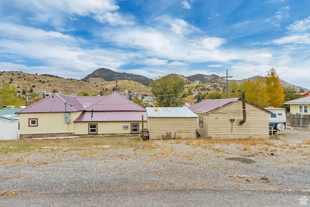 11 W Main St, Eureka, UT 84628 - rear view of property featuring metal roof, a mountain view, and stucco siding