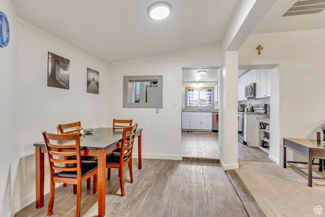 11 W Main St, Eureka, UT 84628 - dining space with light wood-style floors, baseboards, and lofted ceiling