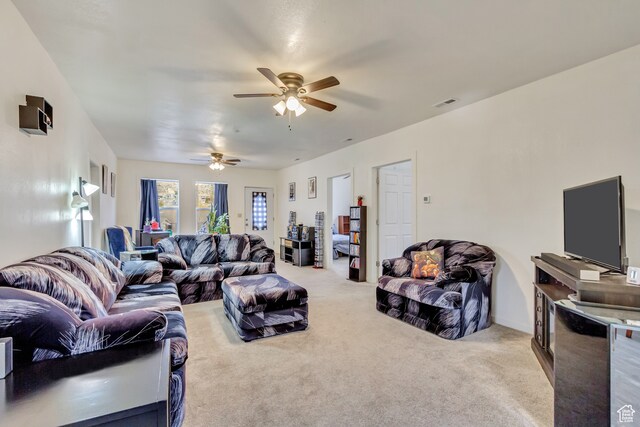 living room featuring light carpet and ceiling fan