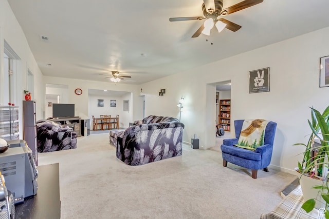 carpeted living room featuring ceiling fan