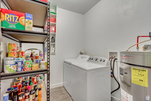 washroom with water heater, hardwood / wood-style flooring, and washing machine and clothes dryer