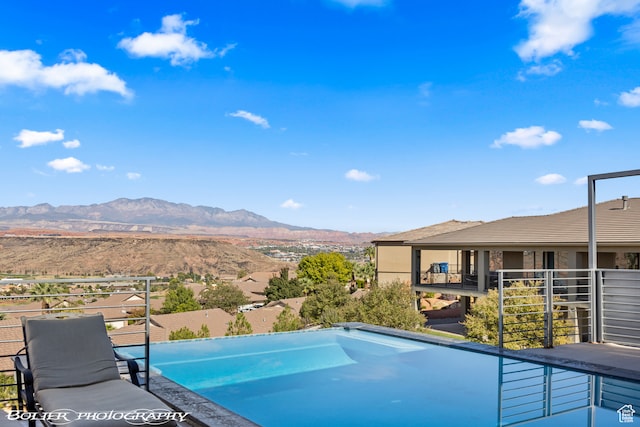 view of swimming pool with a mountain view