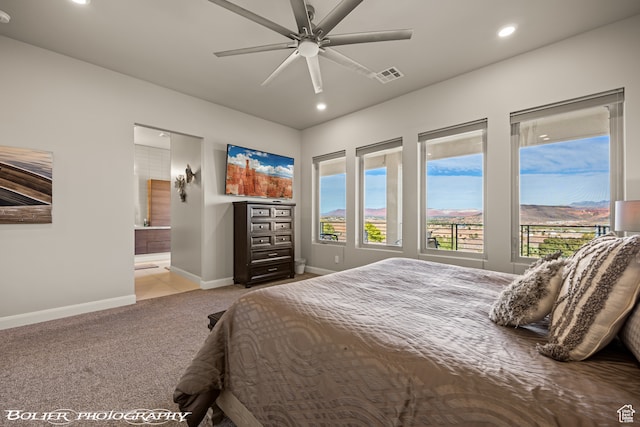 carpeted bedroom with ceiling fan and connected bathroom