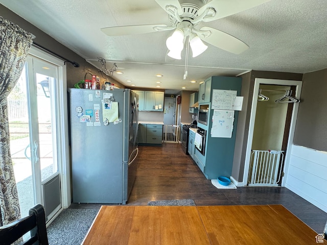 kitchen featuring light countertops, ceiling fan, freestanding refrigerator, and plenty of natural light