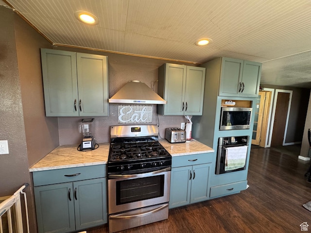 kitchen with stainless steel appliances, recessed lighting, dark wood finished floors, and wall chimney exhaust hood