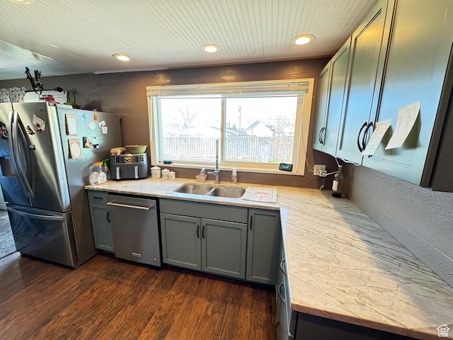 kitchen with stainless steel appliances, light countertops, gray cabinets, and a sink