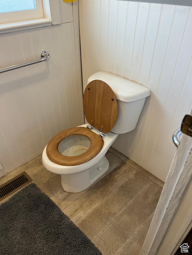 bathroom featuring toilet, visible vents, and wood finished floors
