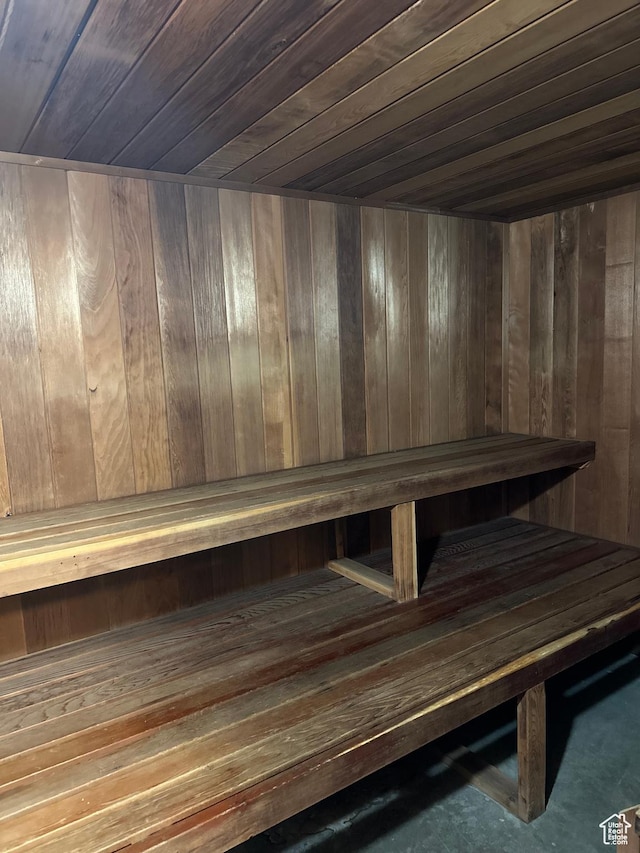 sauna / steam room featuring wood ceiling and wood walls