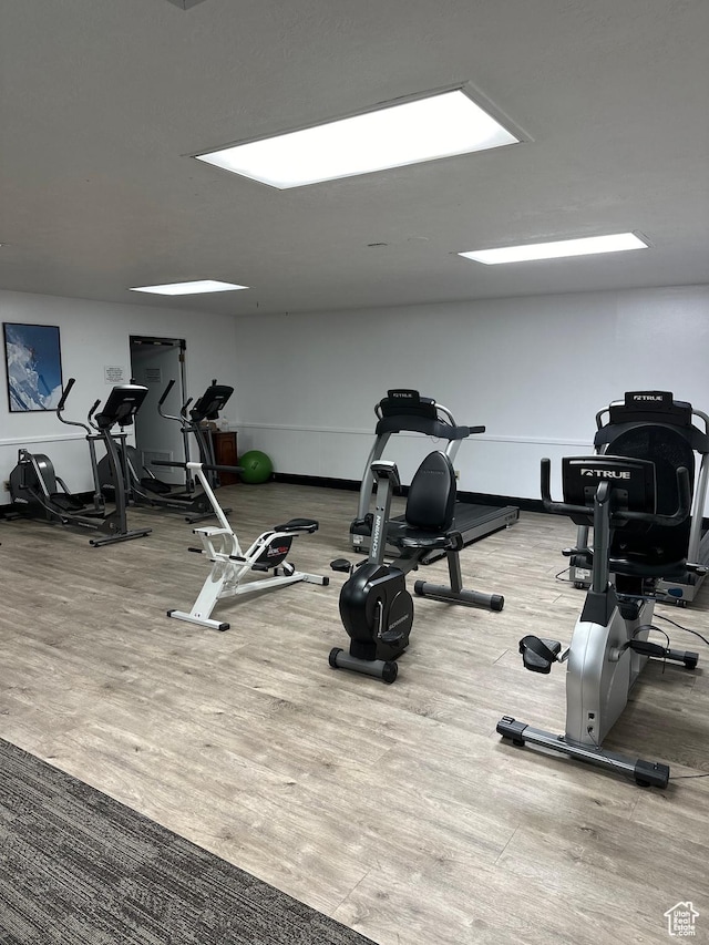 workout area with wood finished floors