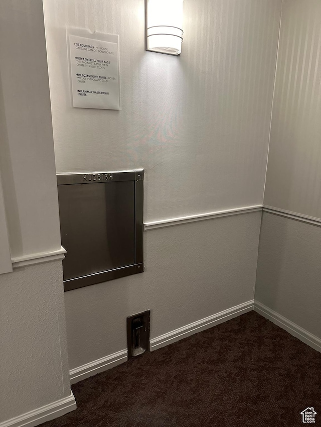 spare room featuring carpet floors and baseboards