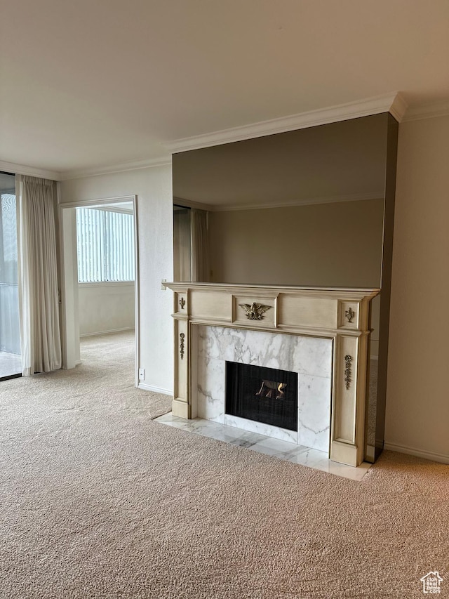 detailed view of crown molding, a high end fireplace, carpet floors, and baseboards