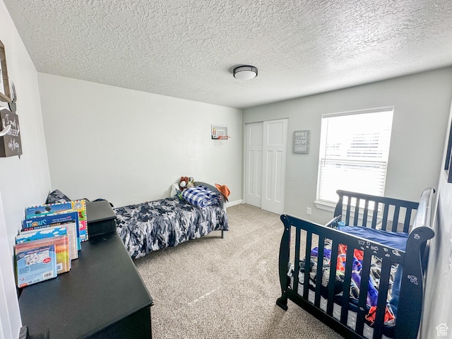 772 W 4375 S, Riverdale, UT 84405 - carpeted bedroom featuring a closet, a textured ceiling, and baseboards