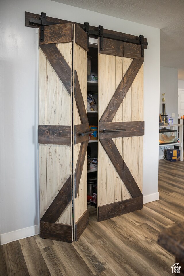 room details featuring hardwood / wood-style floors and a barn door