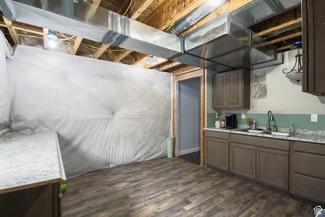 basement featuring dark hardwood / wood-style flooring and sink