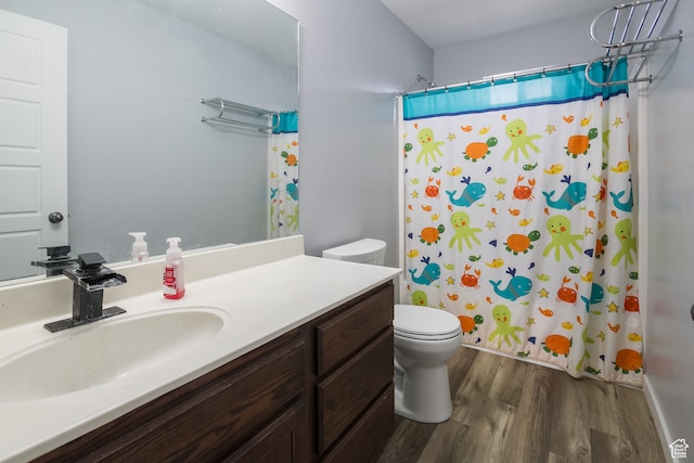 bathroom with curtained shower, vanity, wood-type flooring, and toilet