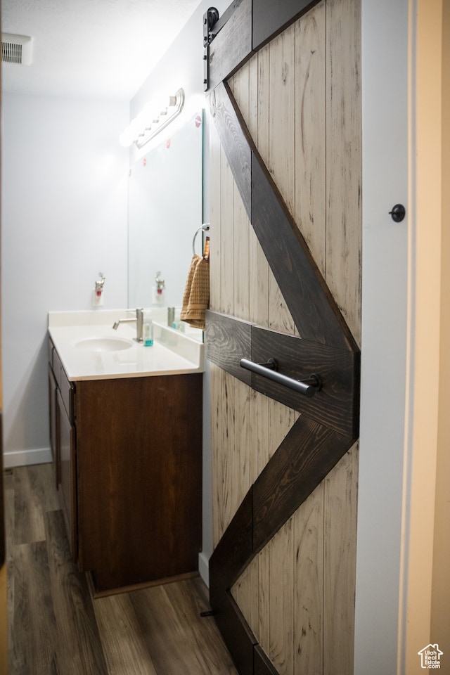 bathroom featuring vanity and hardwood / wood-style flooring