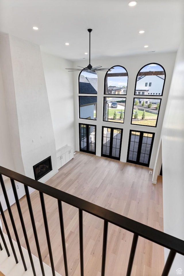 231 S Wiltshire Ln, Saratoga Springs, UT 84045 - unfurnished dining area with wood finished floors, ceiling fan, a large fireplace, recessed lighting, and french doors