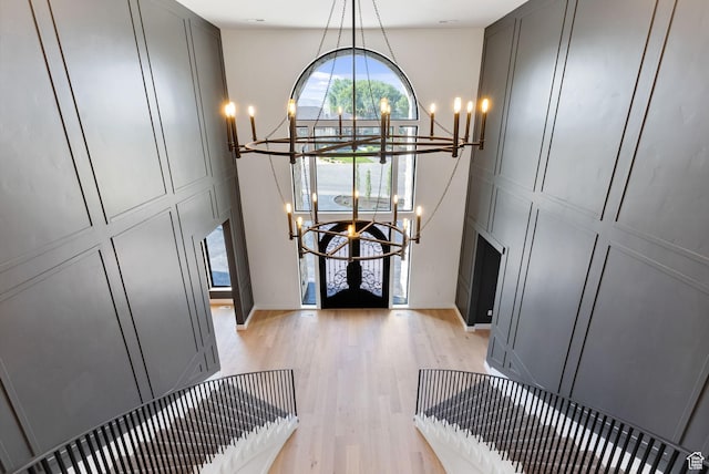231 S Wiltshire Ln, Saratoga Springs, UT 84045 - foyer entrance featuring a chandelier, light wood-style flooring, and a decorative wall