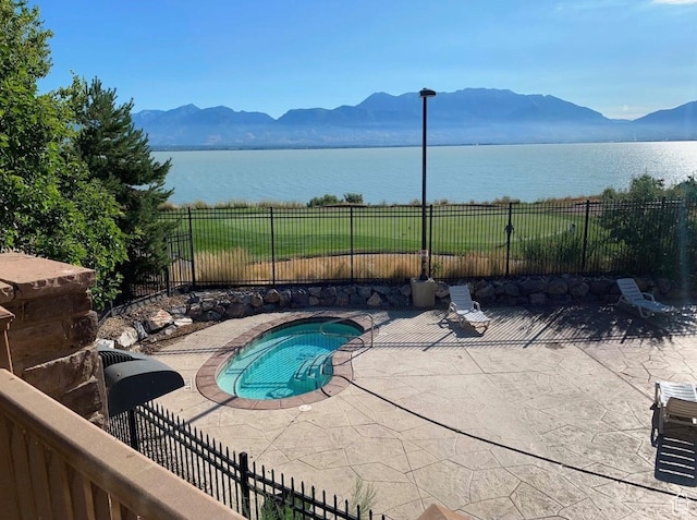 231 S Wiltshire Ln, Saratoga Springs, UT 84045 - view of swimming pool featuring a water and mountain view, a patio, and a fenced backyard