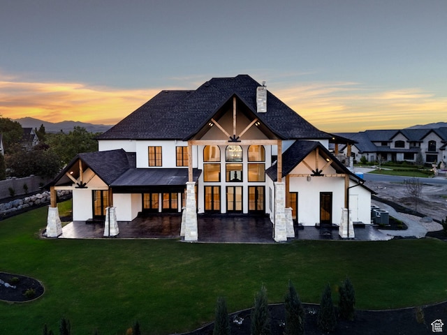 231 S Wiltshire Ln, Saratoga Springs, UT 84045 - rear view of house featuring stucco siding, a lawn, cooling unit, a chimney, and a shingled roof