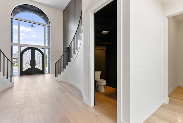 231 S Wiltshire Ln, Saratoga Springs, UT 84045 - foyer featuring stairs, french doors, light wood-style floors, a high ceiling, and baseboards