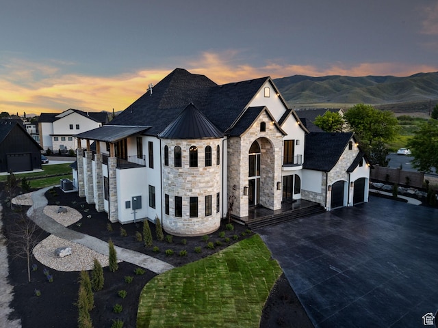 231 S Wiltshire Ln, Saratoga Springs, UT 84045 - french country inspired facade featuring stone siding, an attached garage, driveway, metal roof, and a standing seam roof