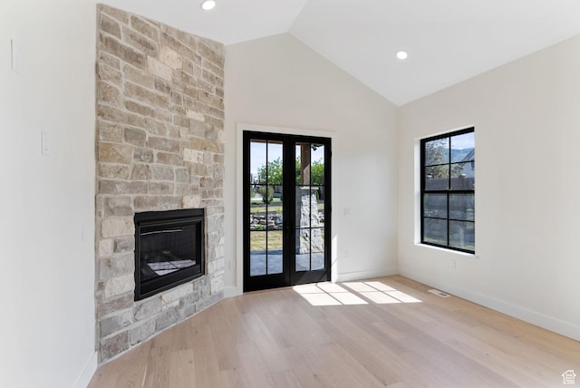 231 S Wiltshire Ln, Saratoga Springs, UT 84045 - doorway to outside with wood finished floors, a stone fireplace, baseboards, high vaulted ceiling, and recessed lighting