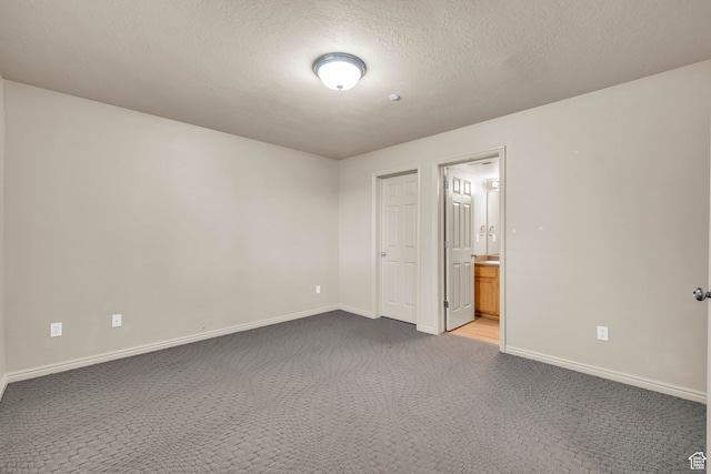 929 W 670 S Unit 1, Pleasant Grove, UT 84062 - unfurnished bedroom with a textured ceiling, carpet flooring, and ensuite bathroom
