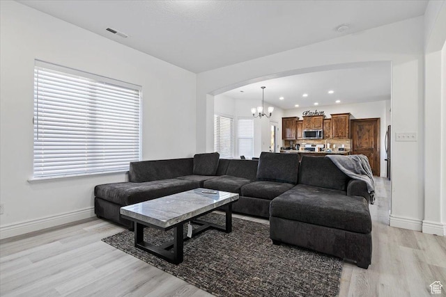 787 E 1950 S, Lehi, UT 84043 - living area with a chandelier, light wood finished floors, baseboards, arched walkways, and recessed lighting