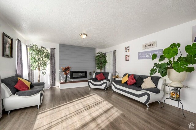 5092 W 4100 S, West Valley City, UT 84120 - living room featuring wood finished floors, a textured ceiling, and a fireplace