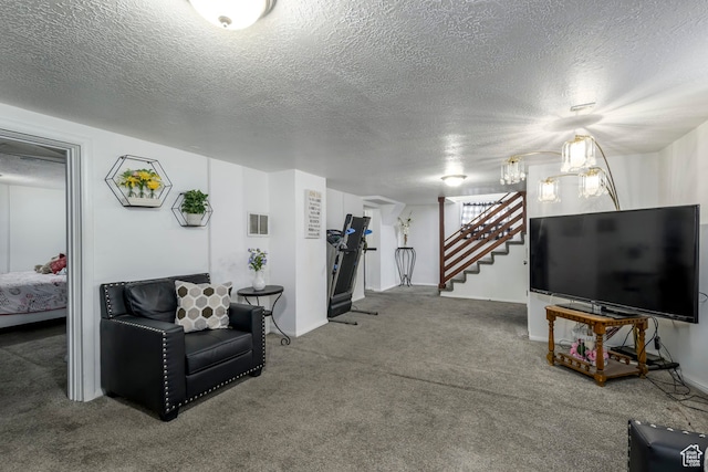 carpeted living room featuring a textured ceiling