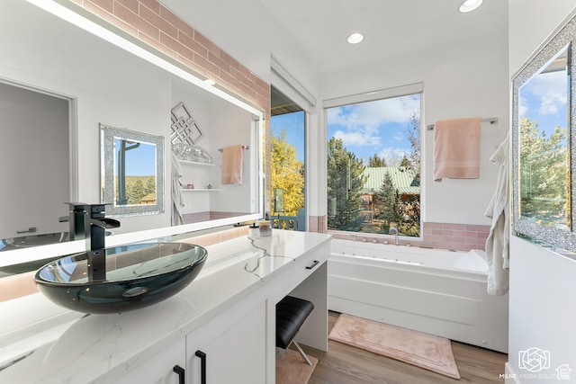 780 W Hillside Dr, Pine Valley, UT 84781 - bathroom with a bath, hardwood / wood-style flooring, vanity, and tasteful backsplash