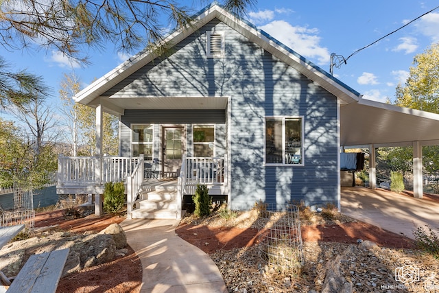 bungalow featuring a carport and covered porch