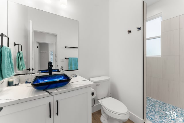 780 W Hillside Dr, Pine Valley, UT 84781 - bathroom featuring tiled shower, vanity, hardwood / wood-style flooring, and toilet