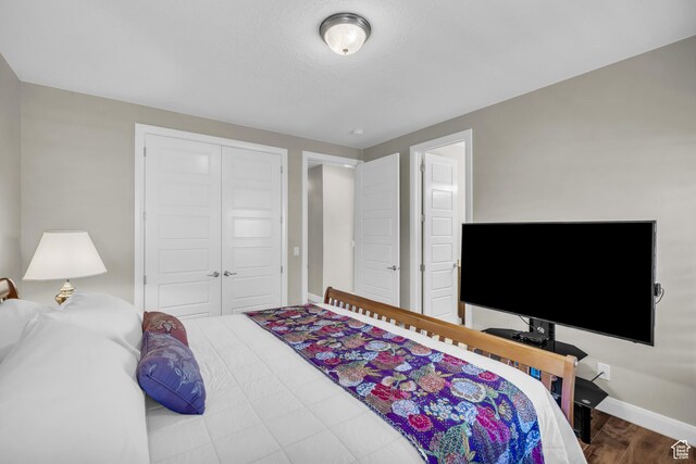 3277 E 3180 S, St George, UT 84790 - bedroom featuring a closet, wood finished floors, and baseboards