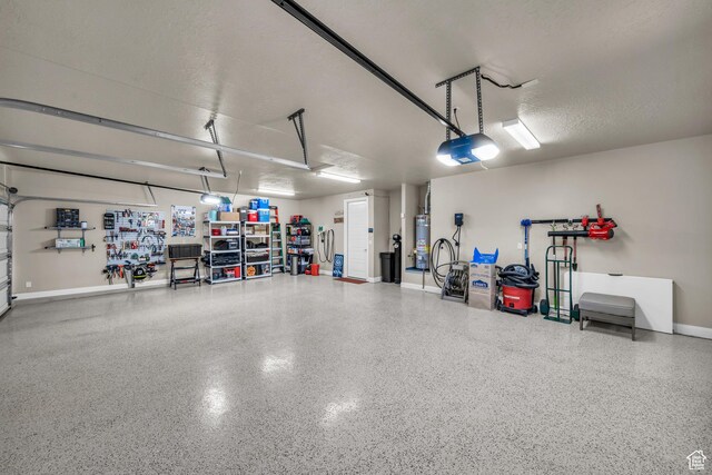 3277 E 3180 S, St George, UT 84790 - garage with water heater, a garage door opener, and baseboards