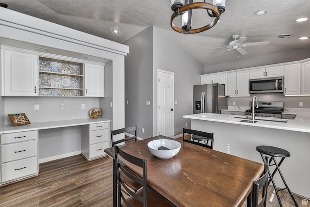 356 N Cactus Ln Unit 9, Washington, UT 84780 - dining space with vaulted ceiling, a textured ceiling, a ceiling fan, dark wood-style floors, and baseboards