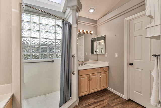 356 N Cactus Ln Unit 9, Washington, UT 84780 - full bathroom featuring a shower with shower curtain, wood finished floors, plenty of natural light, vanity, and vaulted ceiling
