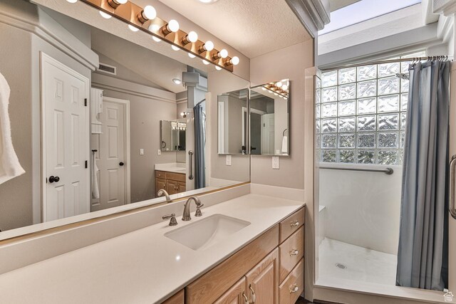 356 N Cactus Ln Unit 9, Washington, UT 84780 - bathroom featuring curtained shower, vanity, and a textured ceiling