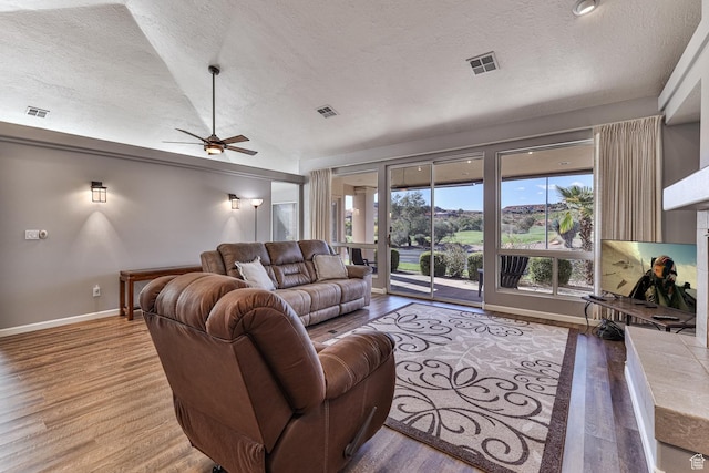 356 N Cactus Ln Unit 9, Washington, UT 84780 - living room featuring a textured ceiling, a ceiling fan, wood finished floors, baseboards, and lofted ceiling