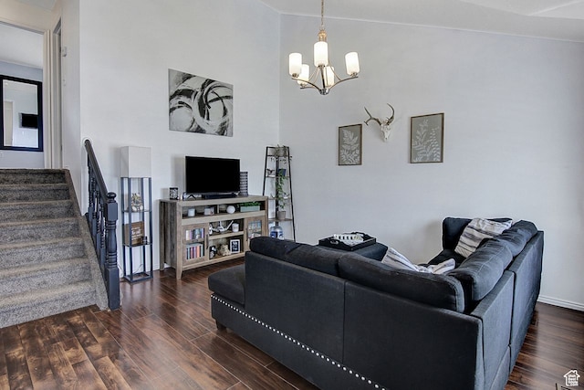 living room with vaulted ceiling, a chandelier, and dark hardwood / wood-style flooring